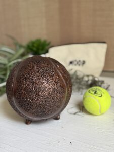 tennis ball urn for dog with a real one for size